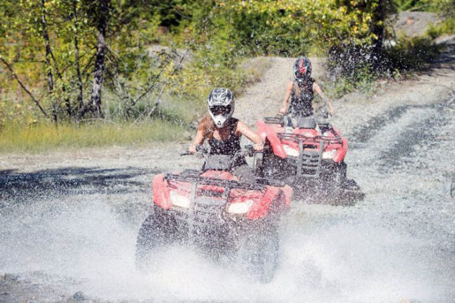 ATV Riders going through water in Whistler