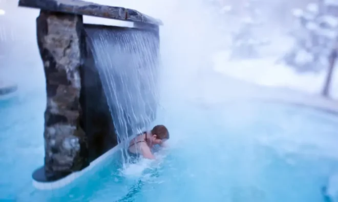 Solo traveller relaxing in the hot pools at Scandinave Spa Whistler
